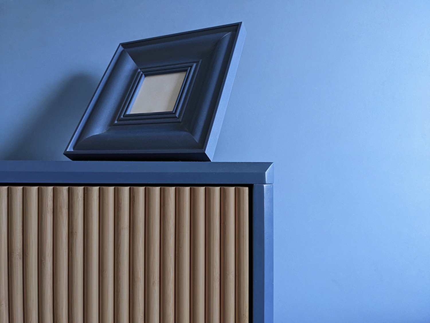 blue-bedroom-bedside-with-frame-interior-design-trends-2022-PGPstudio Picture frame on bedsite table